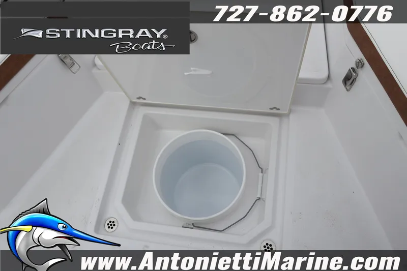 Slide: The Image of 2026 Stingray 236 CC boat interior with storage compartment and bucket. - 32