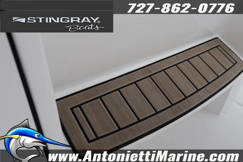 Slide: The Image of 2026 Stingray 236 CC boat deck detail with logo and contact information. - 38