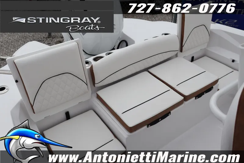 Slide: The Image of 2026 Stingray 236 CC boat seating with white cushions and diamond stitching. - 40