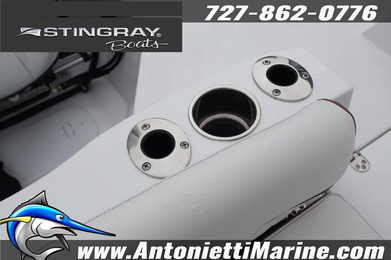 Slide: The Image of 2026 Stingray 236 CC boat interior with cup holders and branding details. - 41