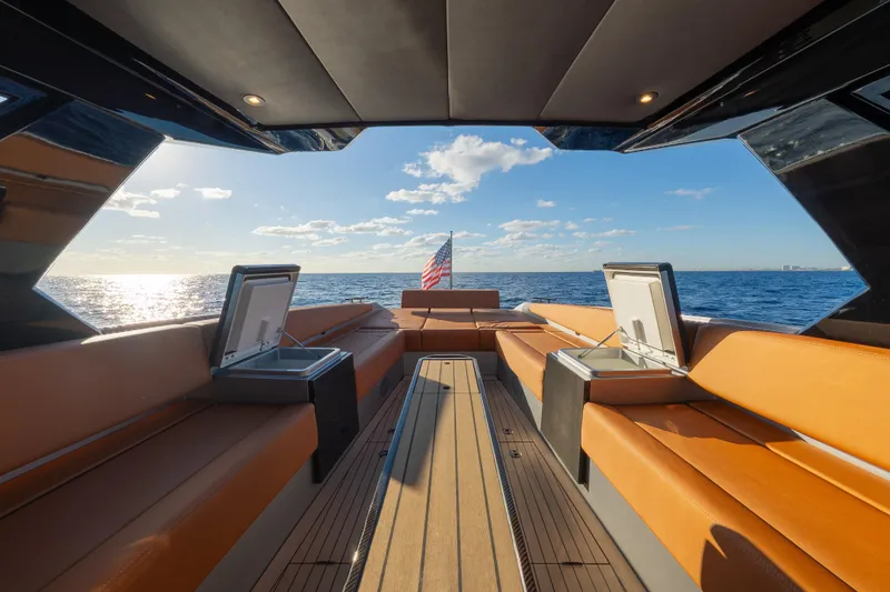 Slide: The Image of 2024 Wajer 55 HT yacht interior with luxurious seating, open sea view, and American flag. - 13