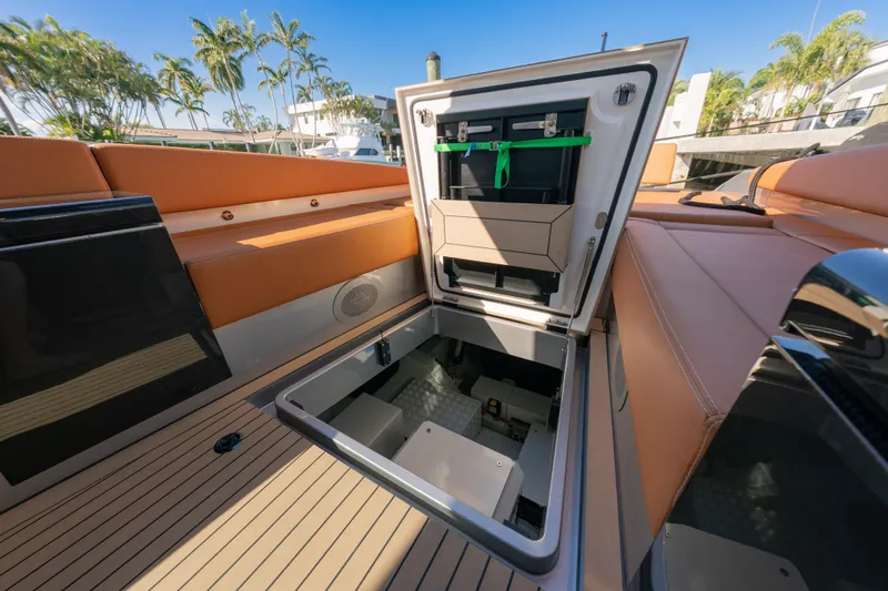 Slide: The Image of 2024 Wajer 55 HT yacht interior with open storage compartment, luxury seating, and teak flooring. - 18