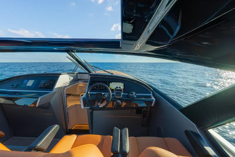 Slide: The Image of 2024 Wajer 55 HT yacht cockpit with ocean view, featuring modern controls and luxurious seating. - 22