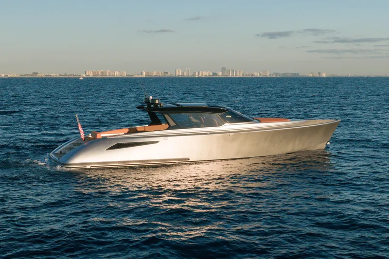 Slide: The Image of 2024 Wajer 55 HT yacht cruising on open water with city skyline in background. - 3