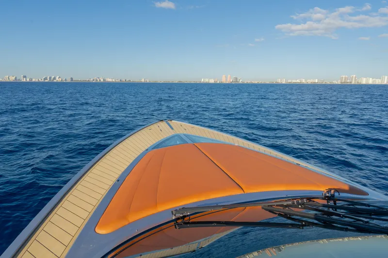 Slide: The Image of 2024 Wajer 55 HT yacht cruising on open sea with city skyline in background. - 38