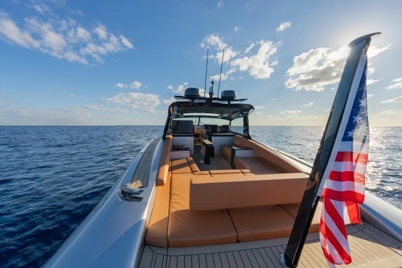 Slide: The Image of 2024 Wajer 55 HT yacht on open sea with American flag, sunny day. - 7