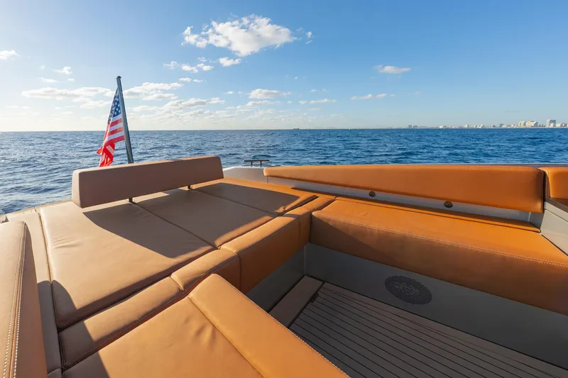 Slide: The Image of 2024 Wajer 55 HT yacht with luxurious seating, ocean view, and American flag. - 9