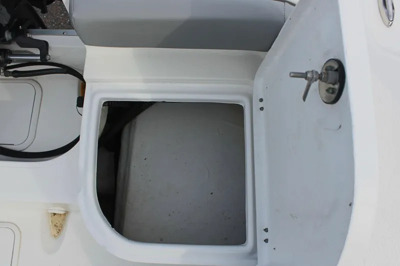 Slide: The Image of Open storage compartment on 2024 Clearwater 2200 CC boat. - 10