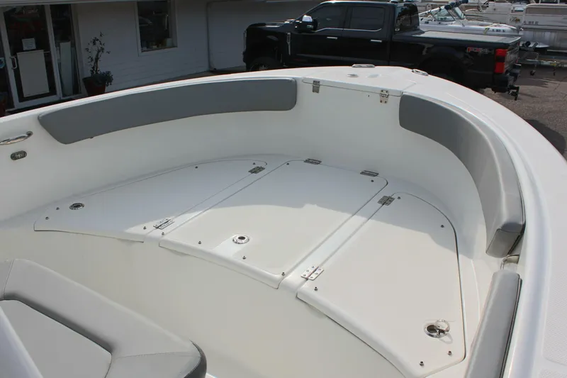 Slide: The Image of 2024 Clearwater 2200 CC boat interior with storage compartments and seating. - 19