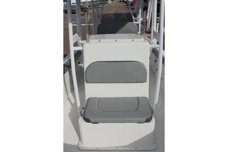 Slide: The Image of 2024 Clearwater 2200 CC boat interior with gray seating and white console. - 25