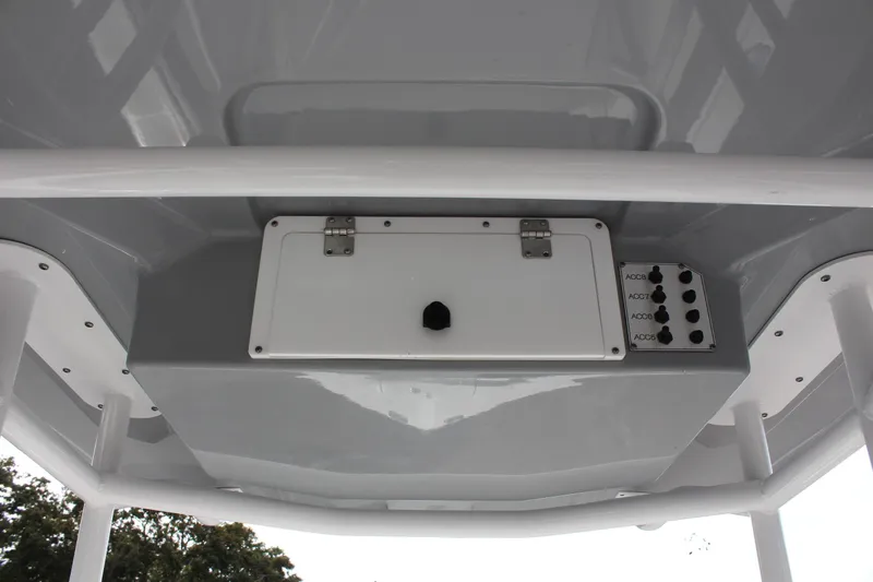 Slide: The Image of 2024 Clearwater 2200 CC boat console with accessory switches and storage compartment. - 27
