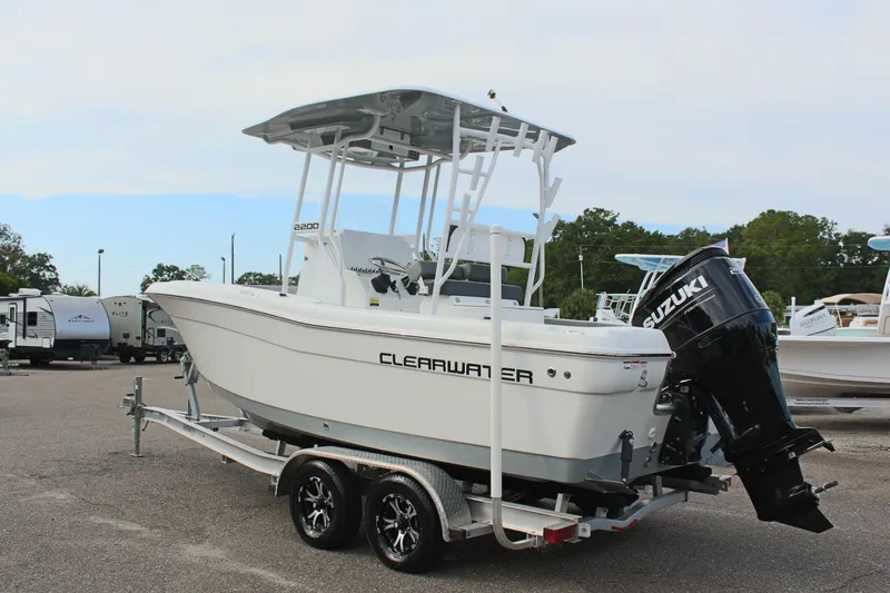 Slide: The Image of 2024 Clearwater 2200 CC boat on trailer with Suzuki outboard motor. - 8