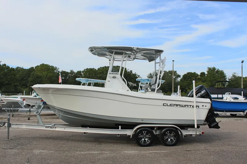 The Image of 2024 Clearwater 2200 CC boat on trailer, featuring sleek design and Suzuki outboard motor. - 1