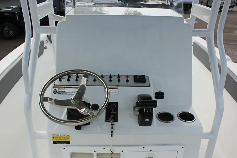 Slide: The Image of 2024 Clearwater 2200 CC boat console with steering wheel and controls. - 16