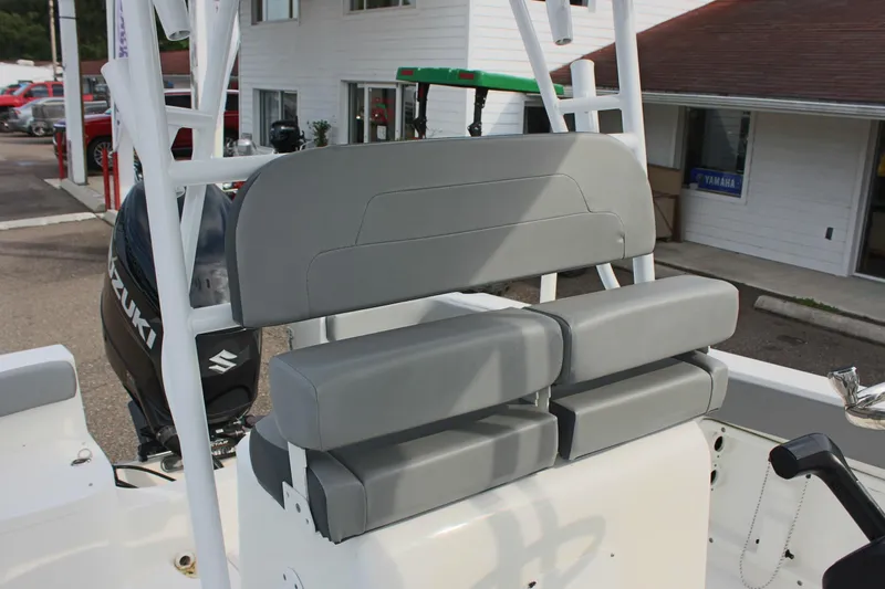Slide: The Image of 2024 Clearwater 2200 CC boat interior with gray seating and Suzuki outboard motor. - 17