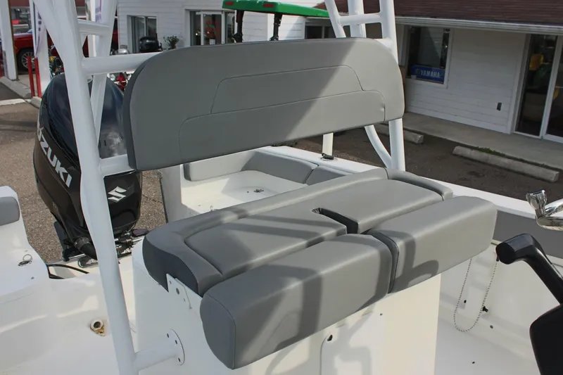Slide: The Image of 2024 Clearwater 2200 CC boat with gray seating and Suzuki outboard motor. - 18