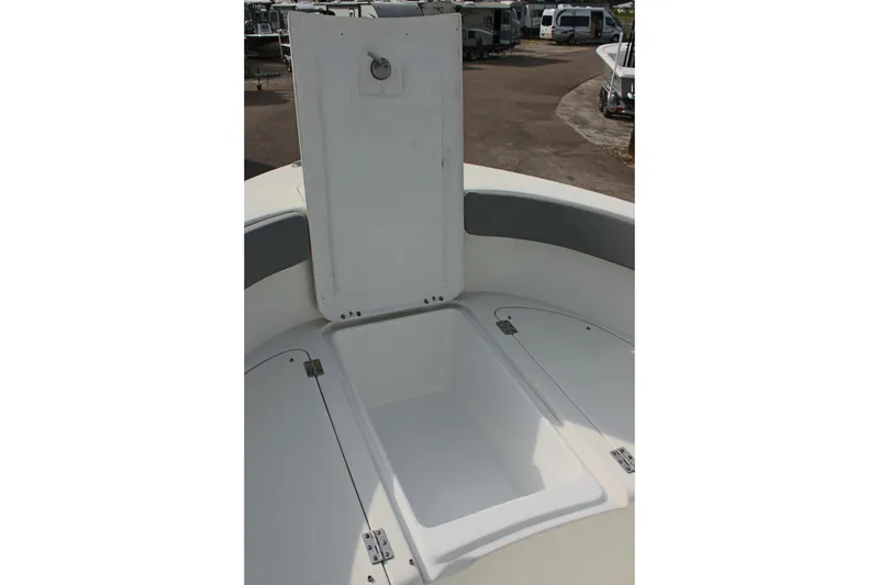 Slide: The Image of 2024 Clearwater 2200 CC boat storage compartment with open hatch, showcasing spacious interior. - 22