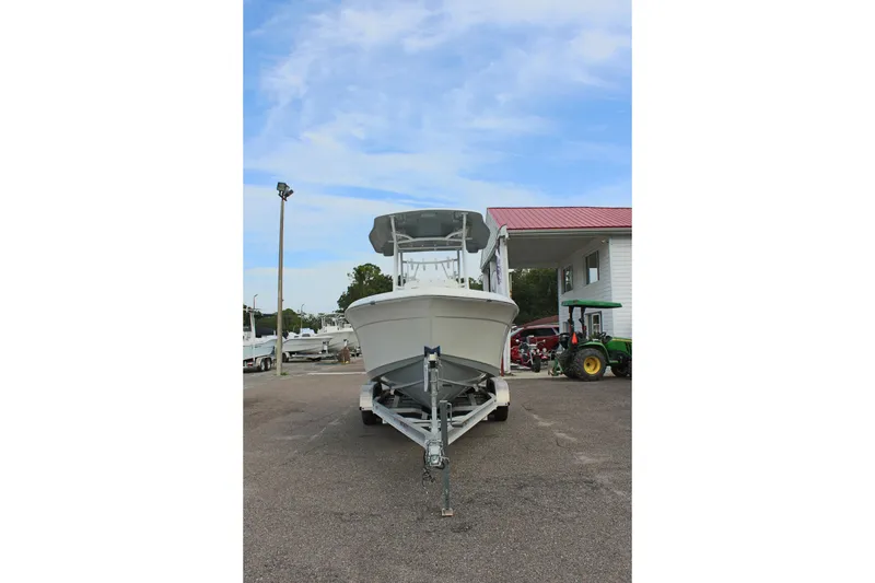 Slide: The Image of 2024 Clearwater 2200 CC boat on trailer, parked outdoors under blue sky. - 3