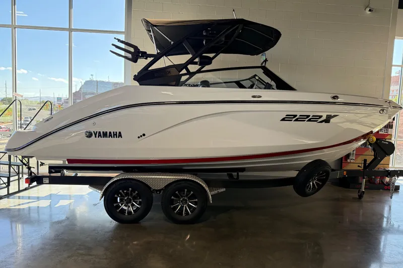 Slide: The Image of 2026 Yamaha Boats 222XD displayed indoors on a trailer, showcasing sleek design and modern features. - 22