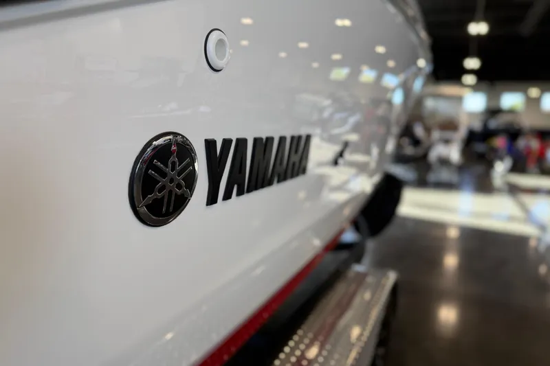 Slide: The Image of 2026 Yamaha Boats 222XD logo on sleek white hull in showroom. - 27
