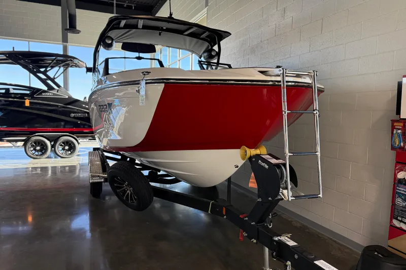 Slide: The Image of 2026 Yamaha Boats 222XD in showroom, red and white design, on trailer. - 29