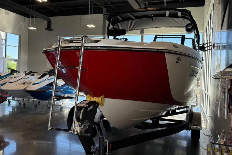 Slide: The Image of 2026 Yamaha Boats 222XD in showroom, red and white hull, trailer attached. - 30