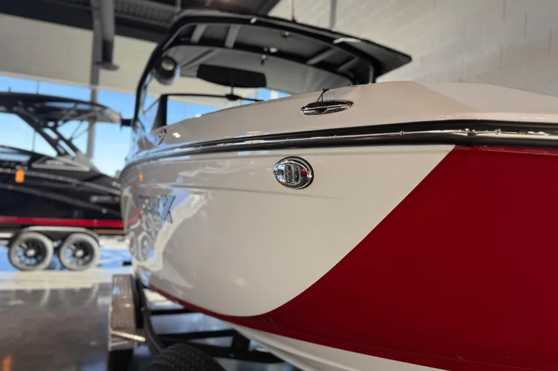 Slide: The Image of 2026 Yamaha Boats 222XD in showroom, featuring sleek red and white design. - 31
