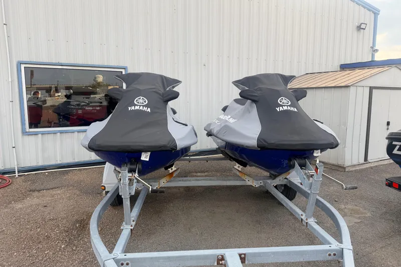 Slide: The Image of Two 2019 Yamaha WaveRunner EXR jet skis covered and parked on a trailer. - 21