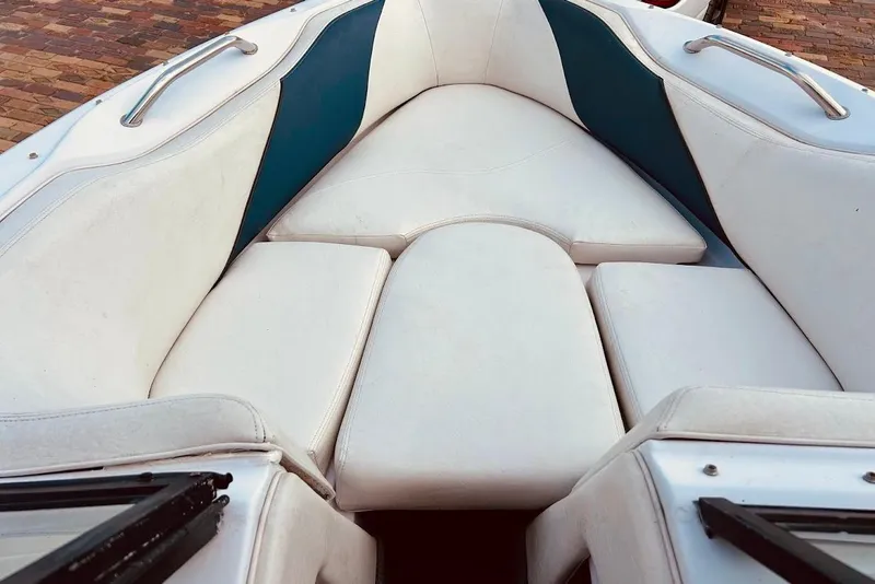Slide: The Image of 2001 Correct Craft Air Nautique boat interior with white and teal seating. - 15