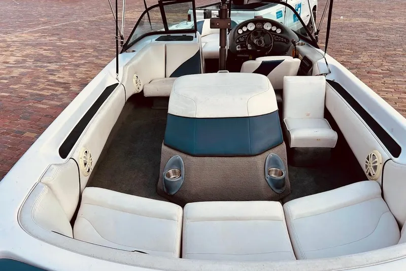 Slide: The Image of 2001 Correct Craft Air Nautique boat interior with white seating and dashboard. - 12