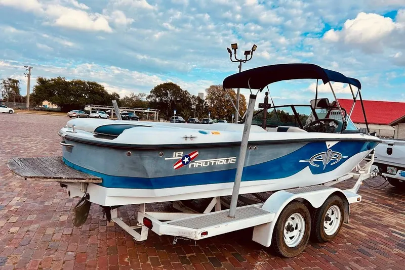 Slide: The Image of 2001 Correct Craft Air Nautique boat on trailer, Florida registration visible. - 2