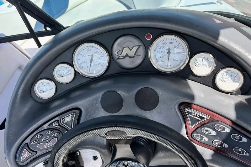 Slide: The Image of Dashboard of a 2001 Correct Craft Air Nautique boat with gauges and controls. - 24