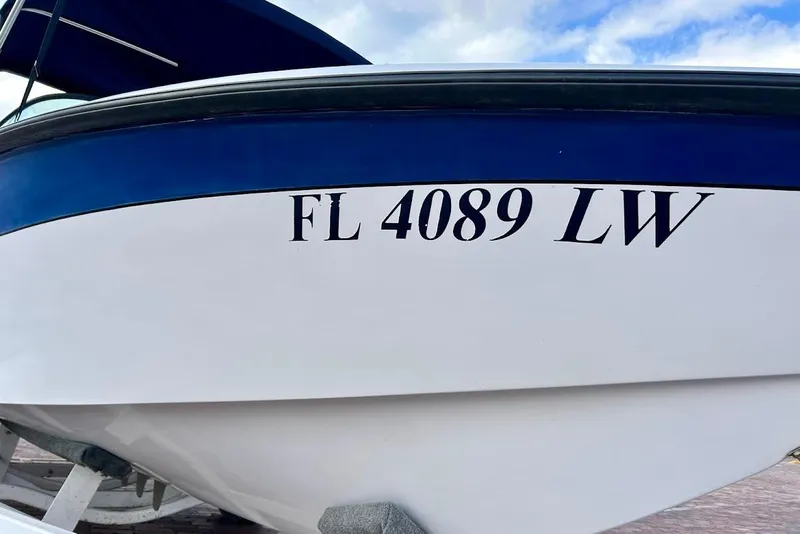 Slide: The Image of 2001 Correct Craft Air Nautique boat on brick pavement under a blue sky. - 6