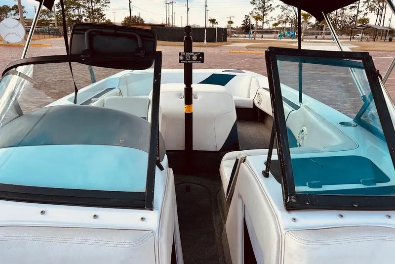 Slide: The Image of 2001 Correct Craft Air Nautique boat on trailer, parked near waterfront building. - 7