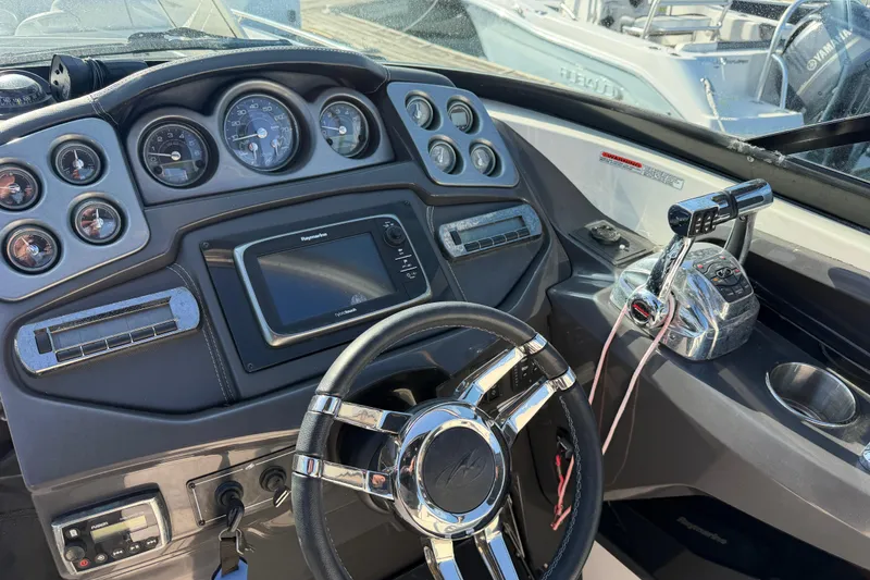 Slide: The Image of Dashboard of a 2012 Monterey 328SS Super Sport boat with steering wheel and controls. - 10