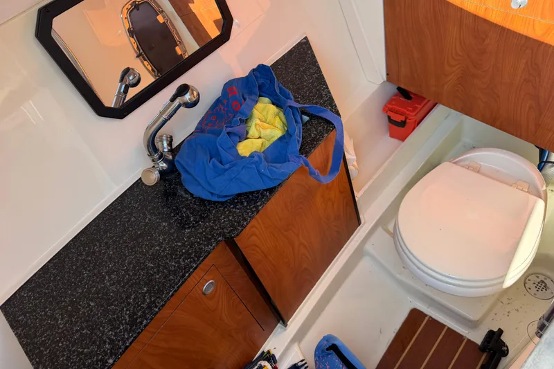 Slide: The Image of Interior of 2012 Monterey 328SS Super Sport boat bathroom with sink and toilet. - 11