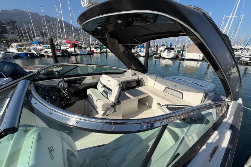 Slide: The Image of 2012 Monterey 328SS Super Sport boat docked in a marina with sailboats. - 14