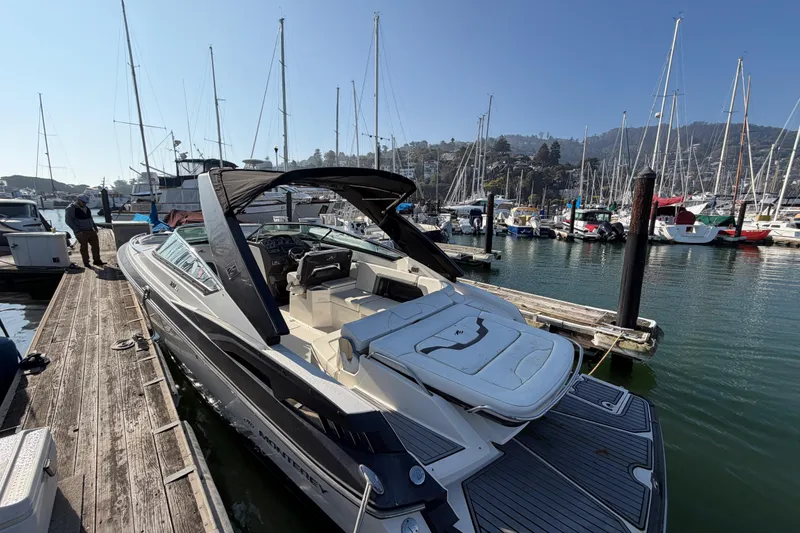 Slide: The Image of 2012 Monterey 328SS Super Sport boat docked at a marina with sailboats. - 15