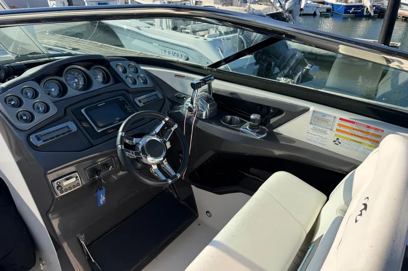 Slide: The Image of Cockpit of a 2012 Monterey 328SS Super Sport boat with steering wheel and control panel. - 19