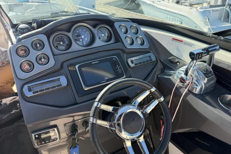 Slide: The Image of Dashboard of a 2012 Monterey 328SS Super Sport boat with steering wheel and controls. - 21