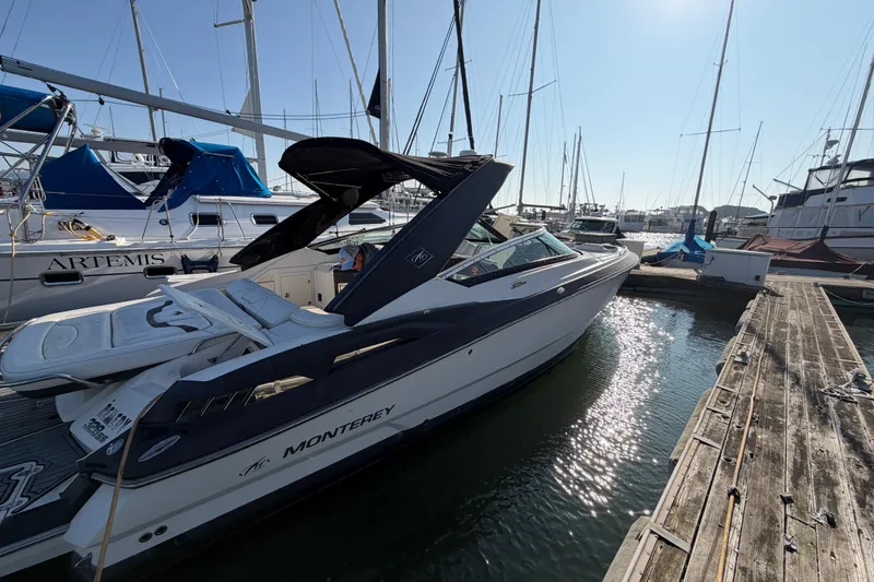 Slide: The Image of 2012 Monterey 328SS Super Sport boat docked at marina under clear sky. - 23