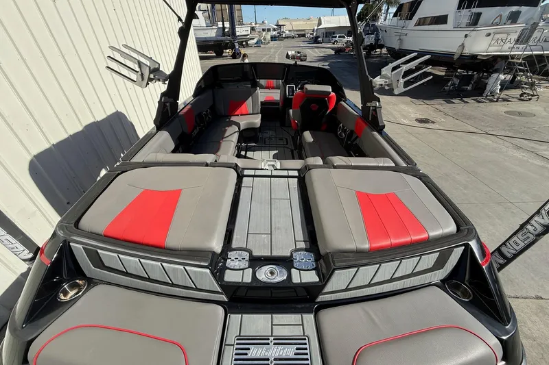 Slide: The Image of 2021 Malibu Wakesetter 23 MXZ boat interior with red and gray seating. - 12