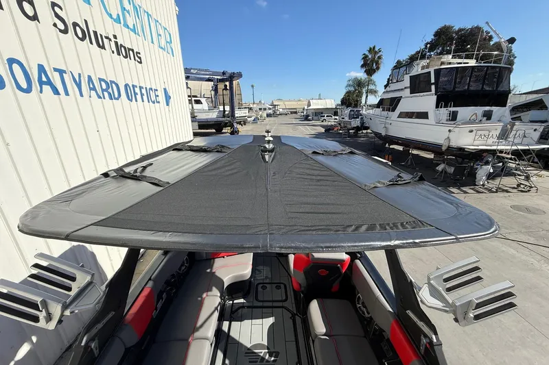 Slide: The Image of 2021 Malibu Wakesetter 23 MXZ boat with cover at a boatyard. - 13