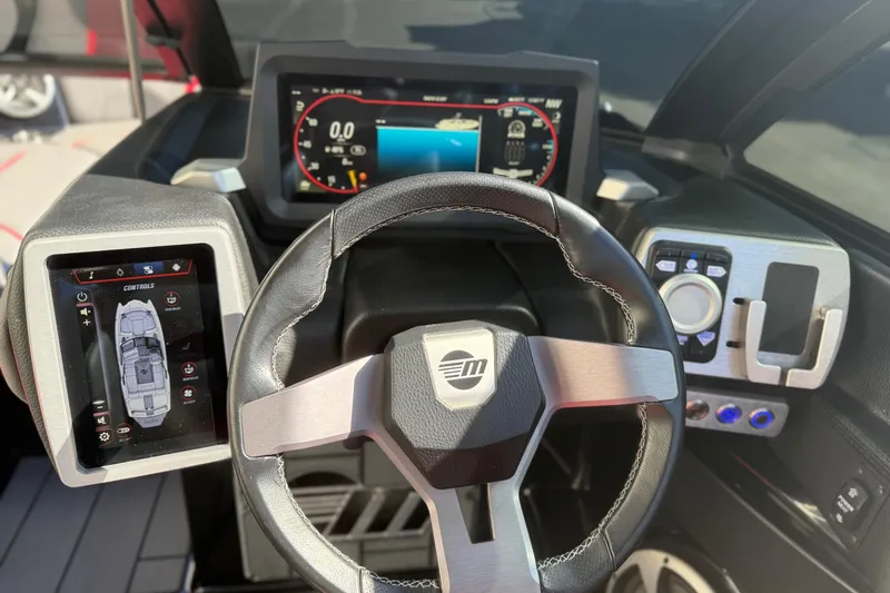 Slide: The Image of 2021 Malibu Wakesetter 23 MXZ dashboard with digital displays and steering wheel. - 15