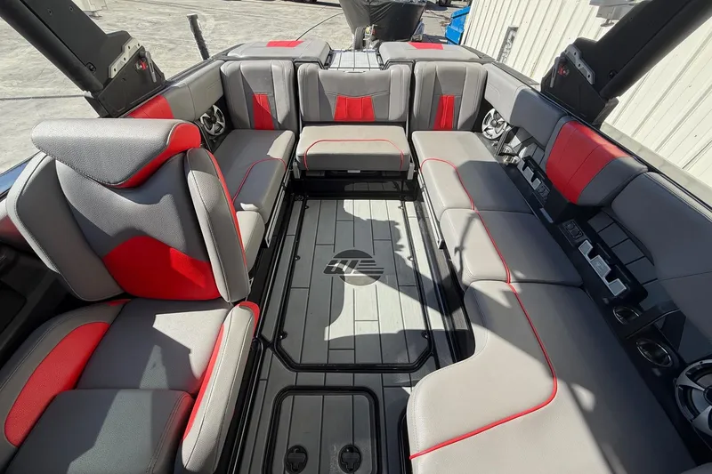 Slide: The Image of 2021 Malibu Wakesetter 23 MXZ interior with gray and red seating, spacious layout. - 20