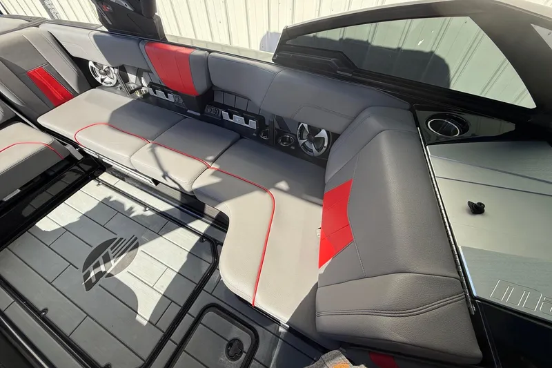 Slide: The Image of 2021 Malibu Wakesetter 23 MXZ interior with gray and red seating, modern design. - 21