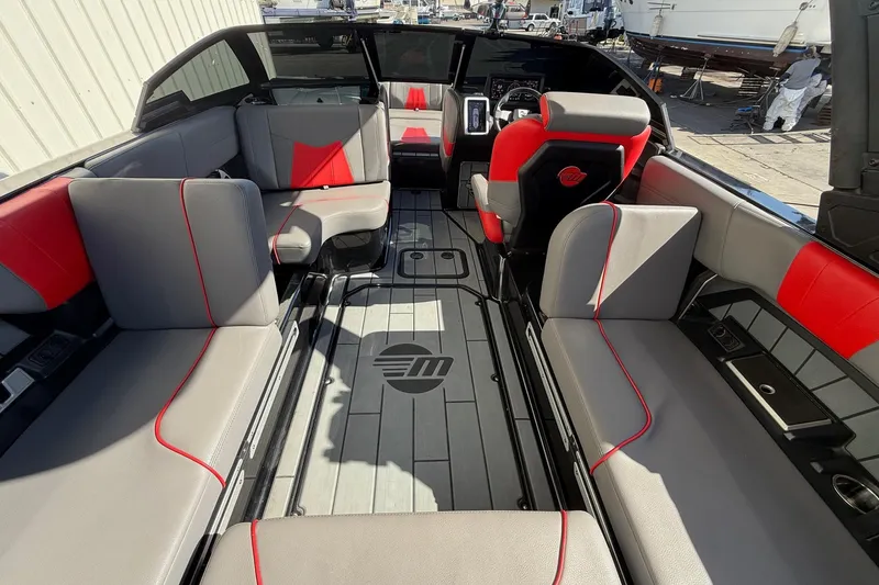 Slide: The Image of 2021 Malibu Wakesetter 23 MXZ interior with gray and red seating, spacious layout. - 24