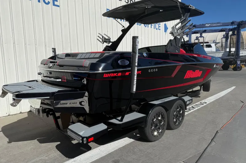 Slide: The Image of 2021 Malibu Wakesetter 23 MXZ boat on trailer, parked outdoors. - 7