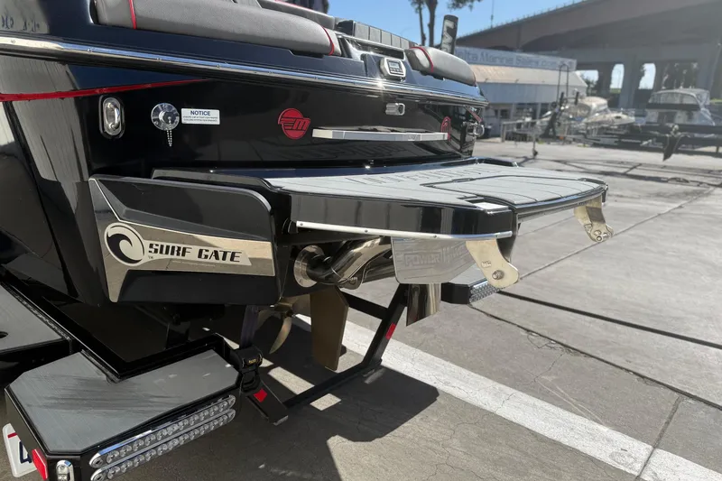 Slide: The Image of 2021 Malibu Wakesetter 23 MXZ with Surf Gate feature at a marina. - 8