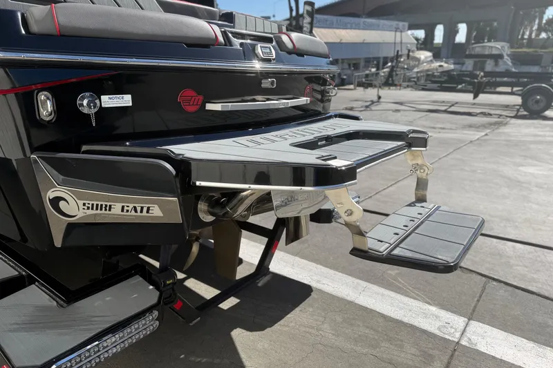 Slide: The Image of 2021 Malibu Wakesetter 23 MXZ boat with Surf Gate feature at marina. - 9